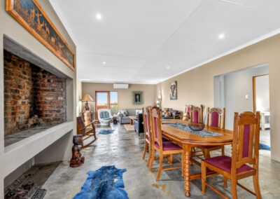 Kudu chalet's indoor fireplace equipped with a dining table